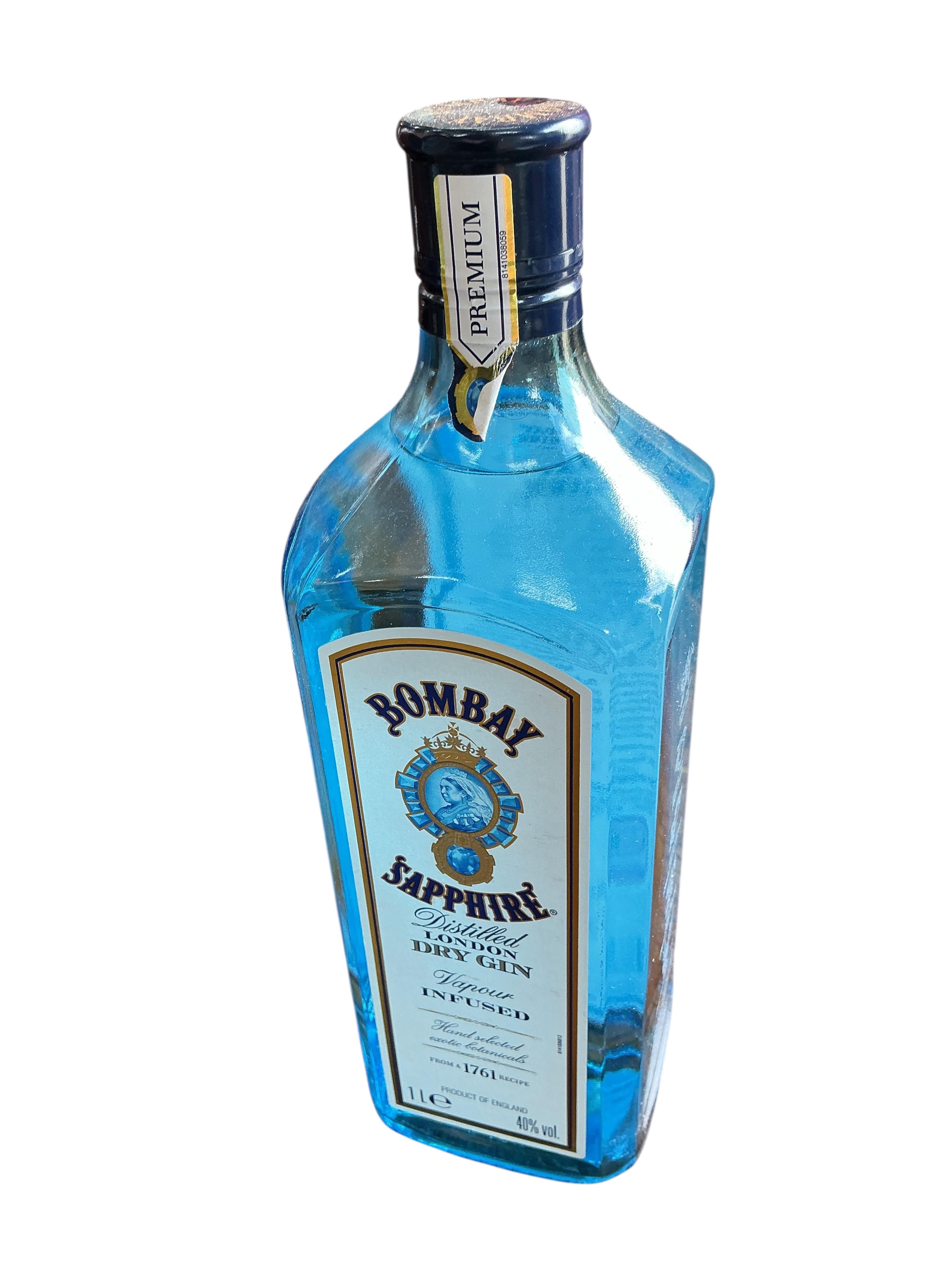 Four bottles of British artisan gin, a bottle of Tanqueray Sevilla and Bombay Sapphire gin and a bottle of Campari. (Provenance, surplus stock from a local wedding company)